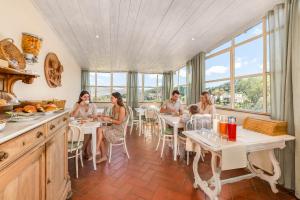 a group of people sitting at tables in a restaurant at B&B Il Connubio - Rooms & Apt between Florence and Chianti in Impruneta