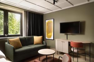 a living room with a couch and a tv at Scandic Neptun in Bergen