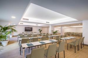 a conference room with tables and chairs and a screen at Occidental Puerto Banús in Marbella +116 photos