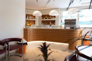 a bar in a restaurant with a counter and chairs at Hotel Diplomatic - Bianchi Hotels in Cesenatico