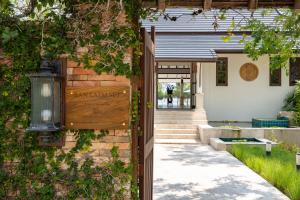 a house with a sign on the side of it at Ban Laem Set - by Sublime Samui Villas in Laem Set Beach
