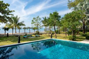 a swimming pool with a view of the ocean at Ban Laem Set - by Sublime Samui Villas in Laem Set Beach