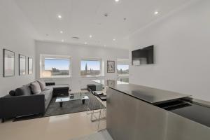 a white living room with a couch and a table at Danhostel Copenhagen City & Apartments in Copenhagen