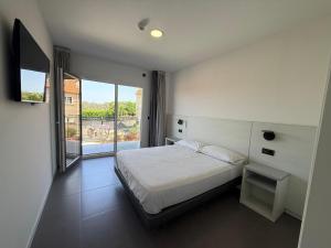 a bedroom with a bed and a large window at Apartamentos Onzamar in Sanxenxo +36 photos