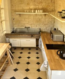 a kitchen with a sink and a counter top at Le Grand Clos Marçon in Marçon