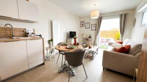a kitchen and a living room with a table at Studio La Parenthèse Sablaise - 3 étoiles in Les Sables-d'Olonne