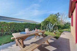 a wooden picnic table sitting on a patio at Chambre d'hote chez Odile in Plougoulm
