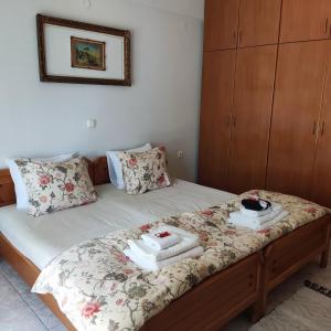 a bedroom with a bed with two towels on it at Serene Vintage in Nea Moudania