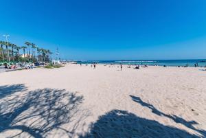 a group of people on a beach with the ocean at Sale e Salsedine in Bari