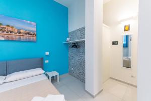 a bedroom with a blue wall and a bed at Sale e Salsedine in Bari