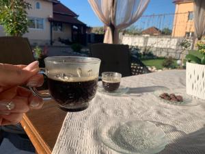 a person holding a glass of beer on a table at CASA LUI MOȘU in Alba Iulia