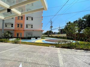 an empty street in front of a building at Cozy place near pavilion mall, upto 4PAX in Biñan