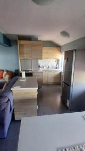 a room with a kitchen with a refrigerator at "Life is Easy Apt" in Varna City