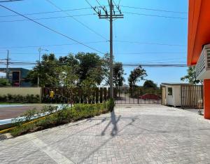 a shadow of a person walking down a street at Cozy place near pavilion mall, upto 4PAX in Biñan