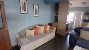 a living room with a couch with pillows on it at "Life is Easy Apt" in Varna City