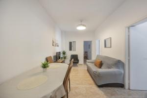 a living room with a table and a couch at Isabel Casa del Mar in Conil de la Frontera