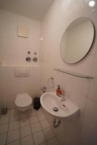 a white bathroom with a sink and a toilet at Radebeul Altkötzschenbroda in Radebeul +7 photos