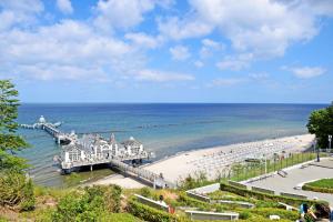 a view of a beach with a pier and the ocean at Ferienanlage in Sellin auf Ruegen in Baabe
