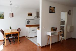 a kitchen and dining room with a table and a desk at Radebeul Altkötzschenbroda in Radebeul
