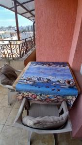 a table sitting on top of a balcony at "Life is Easy Apt" in Varna City