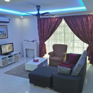 a living room with a couch and a chair at MZ Homestay Kampar in Kampar