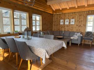 a living room with a table and a couch at Cozy Cabin With Ski Trail Access in Beitostøl