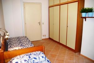 a bedroom with two beds and a closet at Santis Appartament in Grado