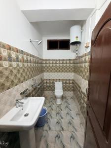 a bathroom with a sink and a toilet at Sangha Homestay in Dirang Dzong