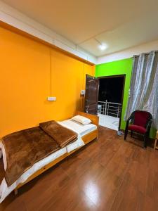a bedroom with a bed and a green wall at Sangha Homestay in Dirang Dzong
