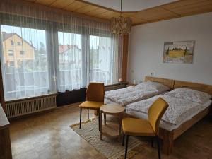 a bedroom with a bed and a table and chairs at Ferienwohnungen Knaus in Knittelfeld
