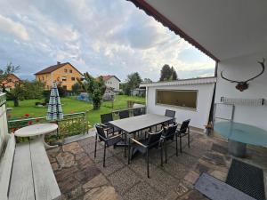 a patio with a table and chairs and a christmas tree at Ferienwohnungen Knaus in Knittelfeld