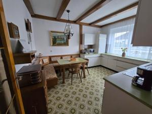 a kitchen and living room with a table and chairs at Ferienwohnungen Knaus in Knittelfeld