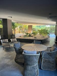a restaurant with chairs and a table with an umbrella at Modern & Cozy Studio for 2 in Saronida Steps from the Beach in Saronida