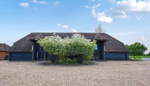 a house with a tree in front of it at The Manor Barn in Canterbury