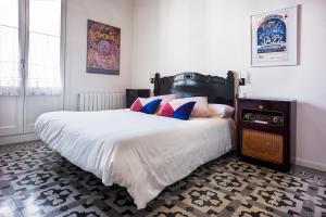a bedroom with a large white bed with pillows at Cal Peó B&B Cardedeu in Cardedeu