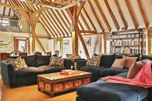 a living room with couches and a coffee table at The Manor Barn in Canterbury