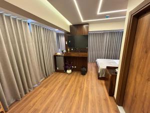 a room with a bedroom with a bed and curtains at Azurea Suites in Alexandria