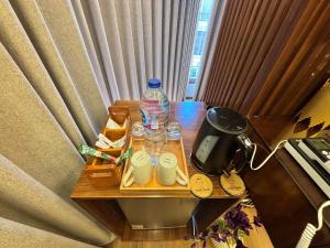 a table with a bottle of water and glasses on it at Azurea Suites in Alexandria +28 photos