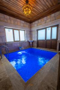 a large indoor swimming pool with a chandelier at Cappadocia Sweet Cave in Nevşehir
