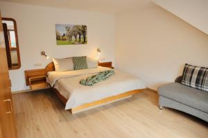 a small bedroom with a bed and a couch at Ferienhof Egger in Tettnang