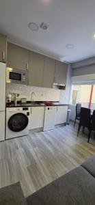 a kitchen with a sink and a stove top oven at Tanez Garden Apartamentos in Madrid