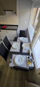 a table with two plates on it in a room at Tanez Garden Apartamentos in Madrid +24 photos