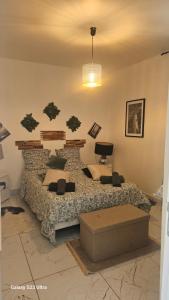 a bedroom with a bed with a couch and a table at Zen et cosy in Marseille