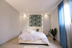 a bedroom with a bed and a blue curtain at La casa di Penelope in Catania