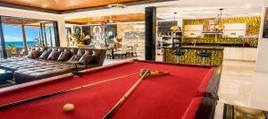 a red pool table in a living room with a billiard at Villa Jacuzzi Seaview Villa in Chaweng Noi Beach