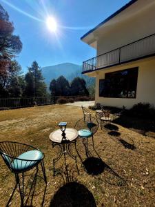 a group of chairs and tables outside of a building at Vikas Hotel And Restaurant in Barot 