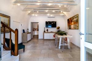 a kitchen and dining room with a table and chairs at Blue Coast Luxury Private Villa, Pool, Jacuzzi, Guesthouse in Bisceglie