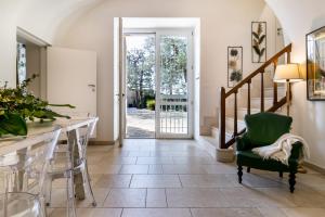 a living room with a table and a green chair at Blue Coast Luxury Private Villa, Pool, Jacuzzi, Guesthouse in Bisceglie