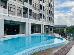 a swimming pool in front of a building at Livingston Hotel in Sandakan