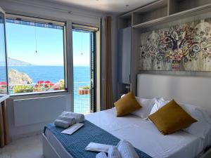 a bedroom with a bed with a view of the ocean at Paradise By The Sea in Taormina
